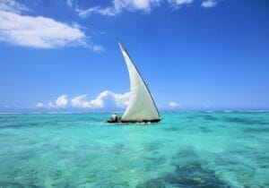 Traditional dhow sailing on turquoise waters of the Indian Ocean in Zanzibar, Tanzania