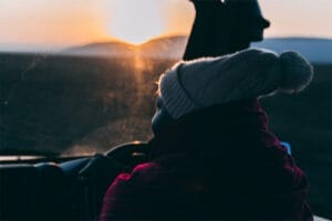 Safari guide driving jeep at sunrise in African savannah