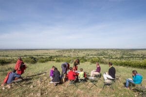 Bush breakfast with guests overlooking Maasai Mara savannah