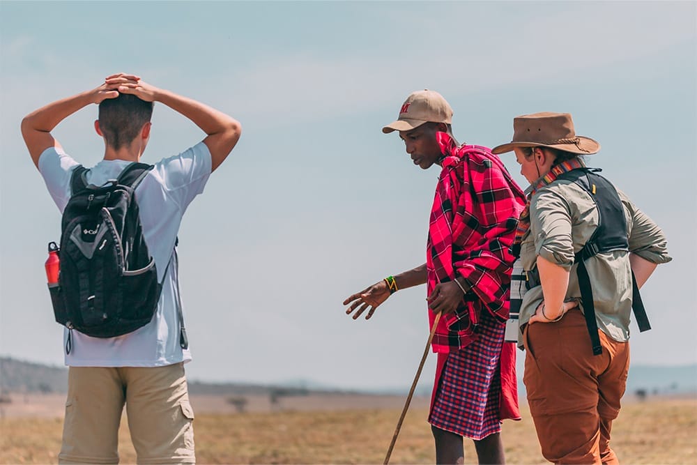 Tourists on guided walking safari with Maasai guide in Kenya