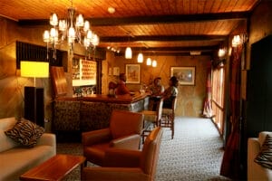 Guests enjoying drinks at safari lodge bar in Kenya