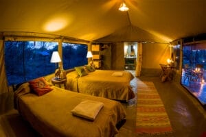 Luxury safari tent interior with twin beds in Maasai Mara