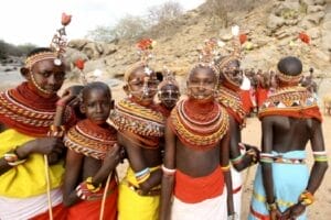 Samburu tribe women and children in traditional beaded attire and headpieces during cultural ceremony in Kenya