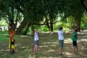 Guide and children with bow and arrow on safari at Samburu Intrepids Tented Camp in Kenya