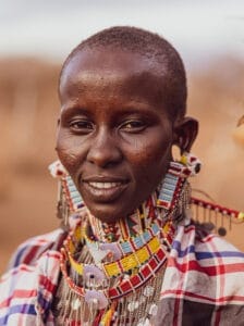 Portrait of a Maasai woman wearing traditional beaded jewelry and colorful attire in East Africa