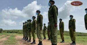 Wildlife rangers in uniform lined up for patrol training with Gamewatchers Safaris in Kenya