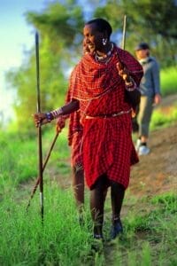 Maasai guides in traditional red shuka leading a walking safari in Kenya