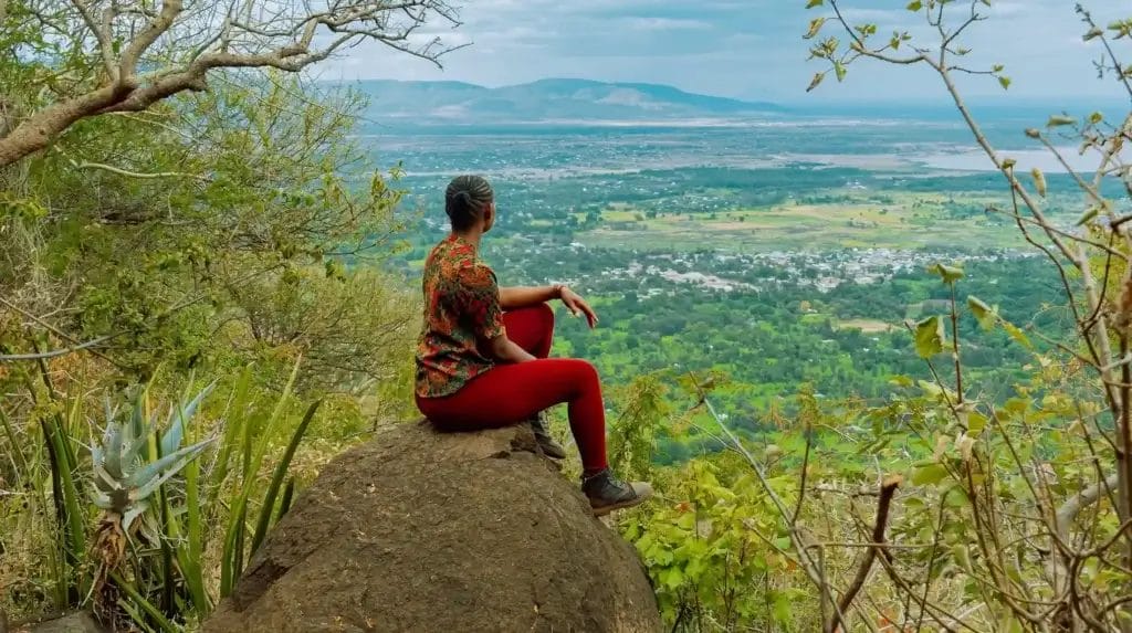 Lady on a rock admiring the view from Kirurumu Manyara Tented Camp.