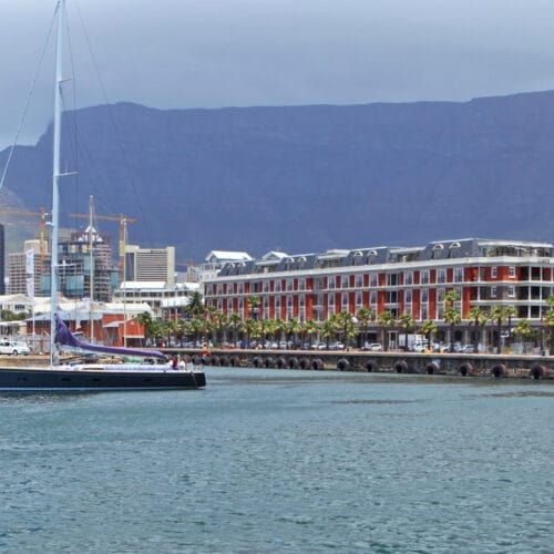 Cape Town Harbour at Victoria and Alfred Waterfront. with boats, downtown buildings and the famous Table Mountain.