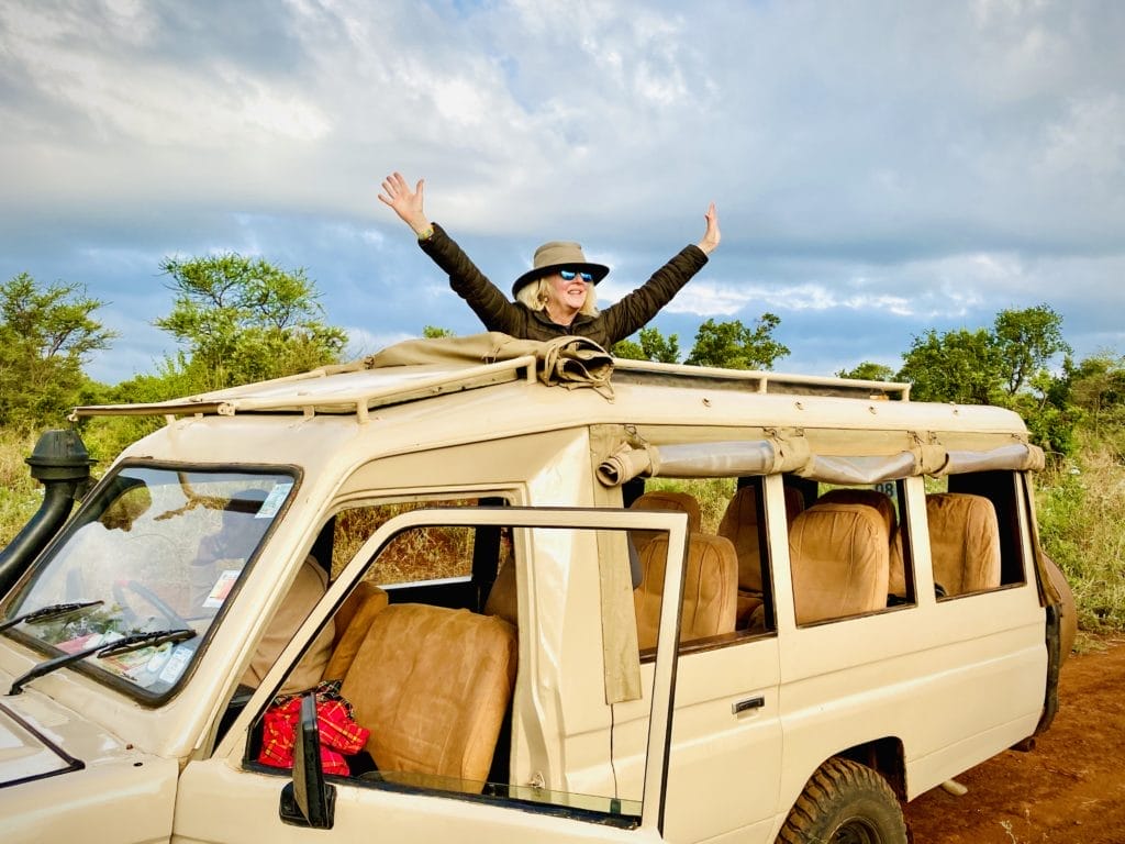 tourist posing in safari vehicle