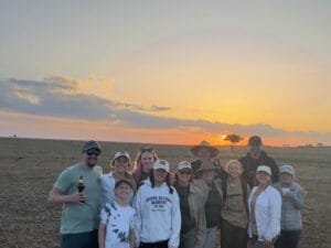 tourists posing In front of sunset