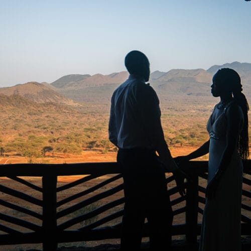 couple on terrace looking over desert