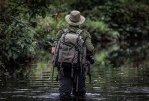 Photographer Wading through River