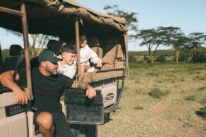 Family in safari vehicle at Ol Kinyei Conservancy photo credit Clare Fisher