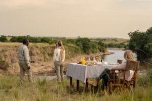 A picture of guests enjoying a bush breakfast at Entim Camp in the Masai Mara Kenya