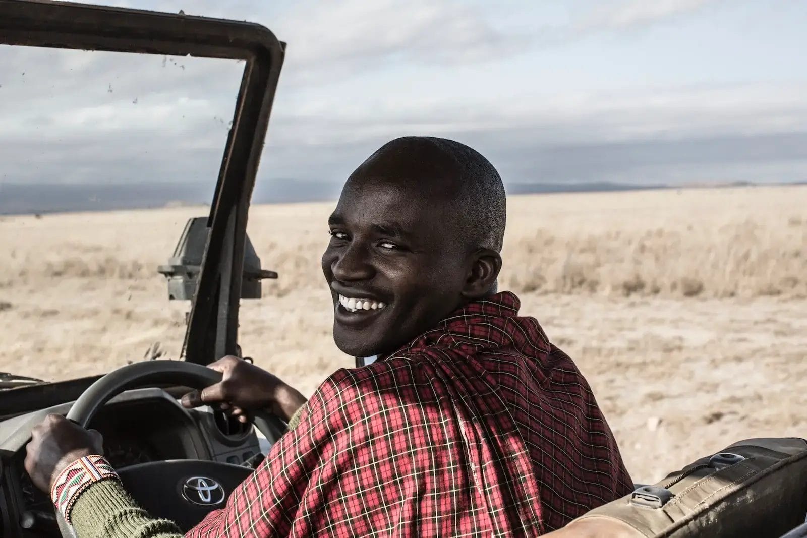 Safari Guide driving safari vehicle in Selenkay Conservancy in Kenya.