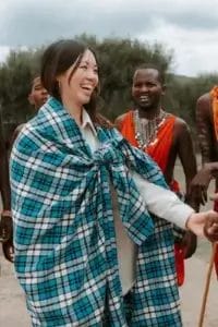 Lady smiling wearing a Maasai shuka at Porini Safari Cottages. Photo credit Celine & Sacha